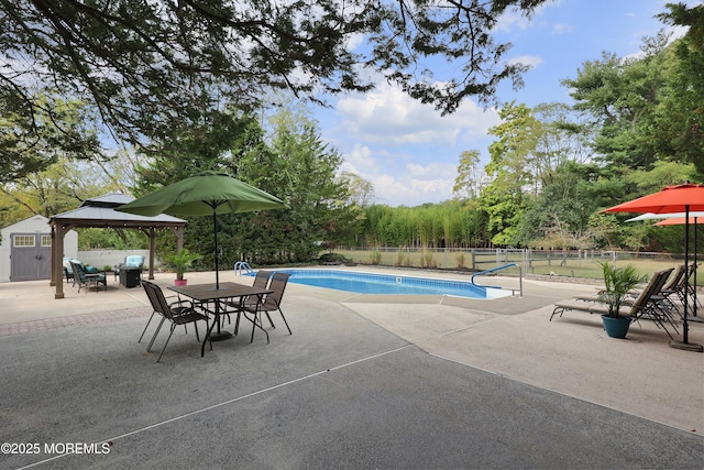 view of pool featuring outdoor dining area, fence, a gazebo, a fenced in pool, and a patio area