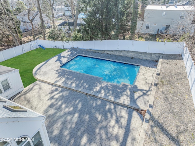 view of pool with a patio, a lawn, a fenced in pool, and a fenced backyard