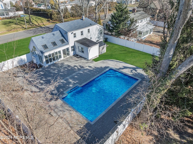 view of swimming pool featuring a yard, a fenced in pool, a fenced backyard, and a patio area