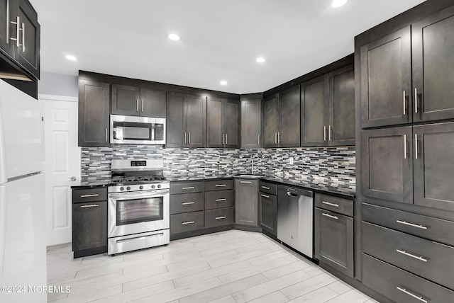 kitchen with decorative backsplash, dark countertops, dark brown cabinets, and appliances with stainless steel finishes