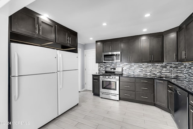 kitchen featuring a sink, recessed lighting, tasteful backsplash, and stainless steel appliances