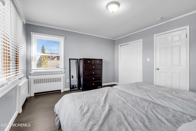 bedroom with baseboards, dark wood finished floors, radiator heating unit, a closet, and crown molding