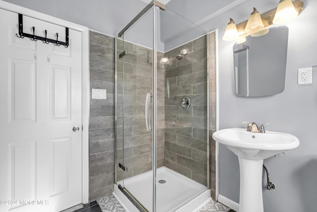 full bath featuring a shower stall and a sink