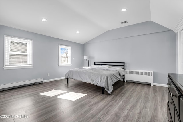 bedroom with visible vents, radiator, a baseboard heating unit, vaulted ceiling, and wood finished floors