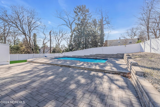 view of pool featuring a patio area, a fenced in pool, and a fenced backyard