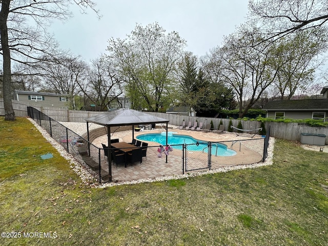 view of swimming pool featuring a fenced in pool, a gazebo, a yard, a fenced backyard, and a patio