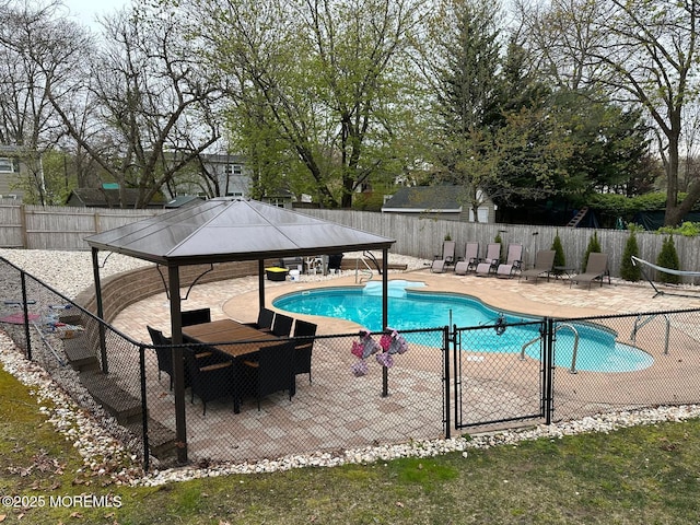 pool featuring a gazebo, fence, and a patio