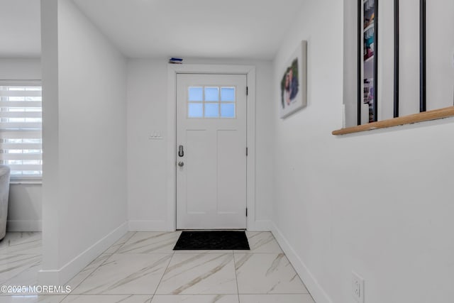 entrance foyer with marble finish floor and baseboards