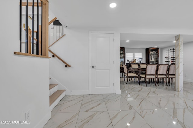 staircase with recessed lighting, baseboards, and marble finish floor