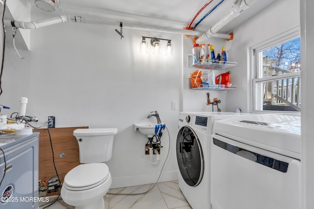 bathroom featuring baseboards, separate washer and dryer, marble finish floor, and toilet