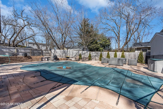 view of swimming pool with a patio area, a fenced in pool, and a fenced backyard