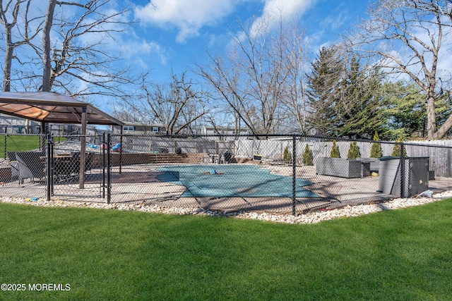 view of pool with a fenced in pool, a patio, a lawn, and fence