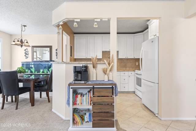 kitchen featuring light tile patterned floors, white appliances, backsplash, and white cabinets