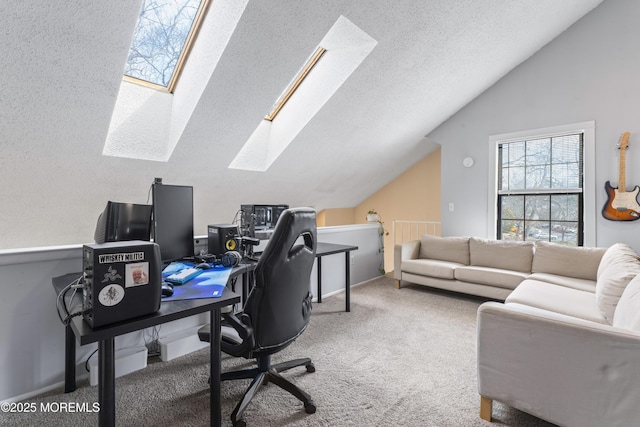 office featuring vaulted ceiling with skylight, a textured ceiling, and carpet flooring