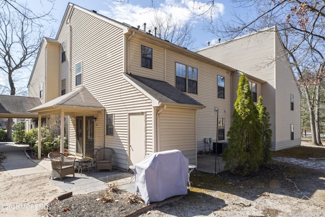 rear view of house featuring a patio and central AC unit