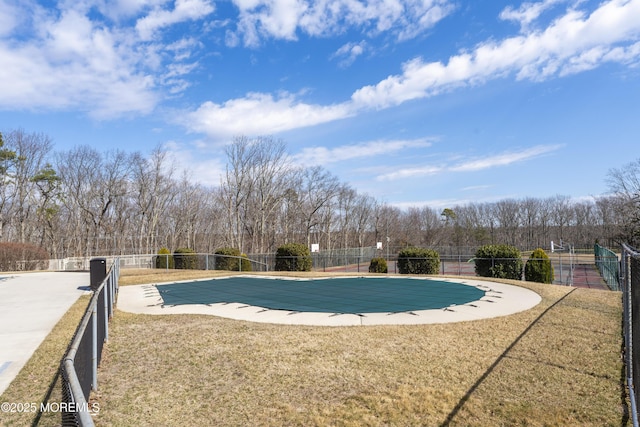 pool with a yard and fence