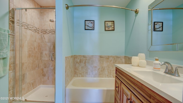 bathroom with a bath, a stall shower, and vanity