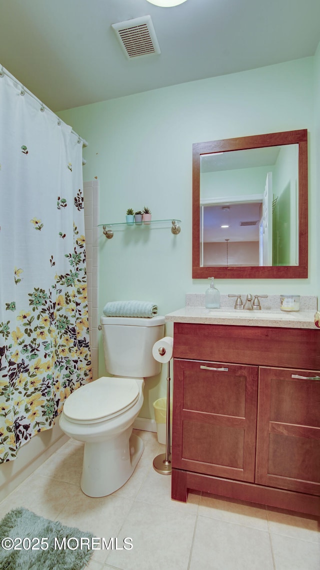 bathroom with tile patterned flooring, toilet, vanity, and visible vents