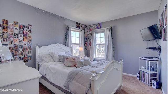 bedroom featuring baseboards and light carpet