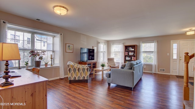 living room with baseboards, visible vents, and dark wood-style flooring