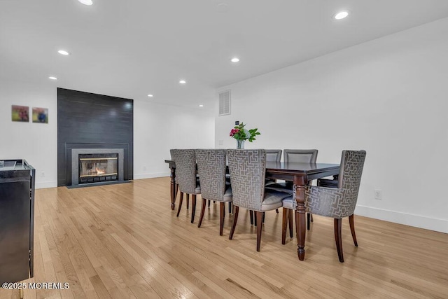 1158 Idalia Ave, Lakewood, NJ 08701 - dining room with recessed lighting, baseboards, light wood-style flooring, and a fireplace