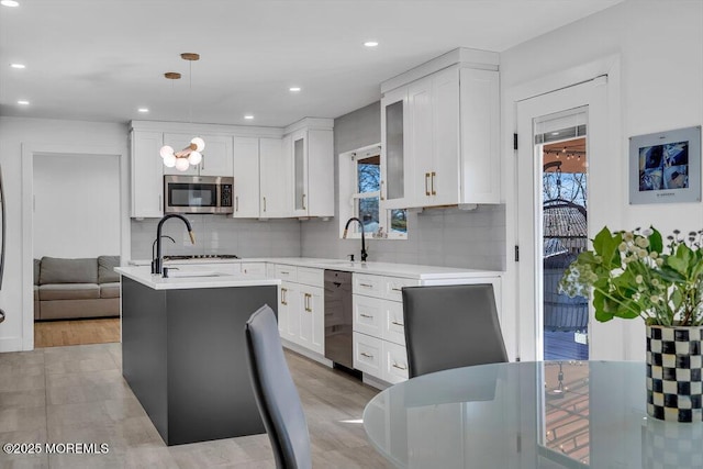 1158 Idalia Ave, Lakewood, NJ 08701 - kitchen featuring white cabinetry, light countertops, tasteful backsplash, and appliances with stainless steel finishes