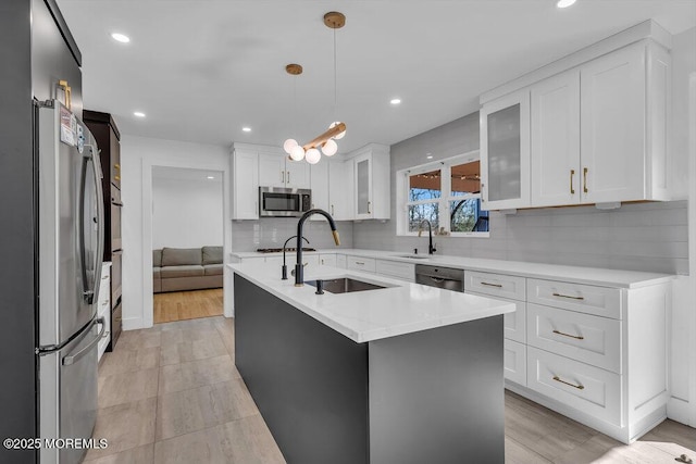 1158 Idalia Ave, Lakewood, NJ 08701 - kitchen featuring a sink, a kitchen island with sink, white cabinetry, and stainless steel appliances