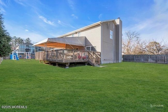 1158 Idalia Ave, Lakewood, NJ 08701 - back of house with a chimney, a lawn, a wooden deck, and fence