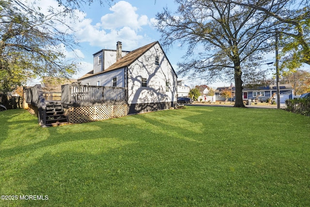 exterior space with a wooden deck, a lawn, and a chimney