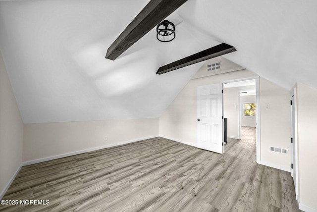 bonus room featuring lofted ceiling with beams, visible vents, baseboards, and wood finished floors