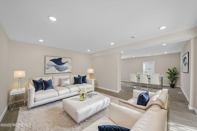 living room with recessed lighting and wood finished floors