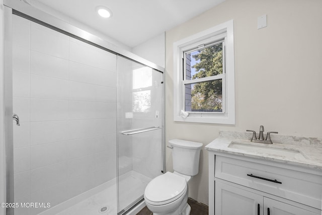 full bathroom featuring vanity, toilet, and a stall shower