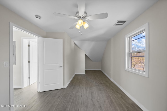 bonus room featuring visible vents, baseboards, wood finished floors, and a ceiling fan