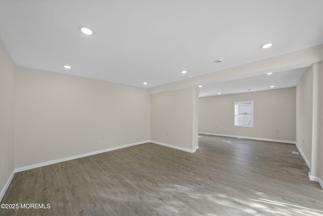 interior space featuring recessed lighting, wood finished floors, and baseboards