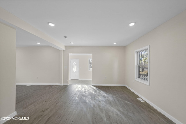 spare room featuring recessed lighting, wood finished floors, visible vents, and baseboards