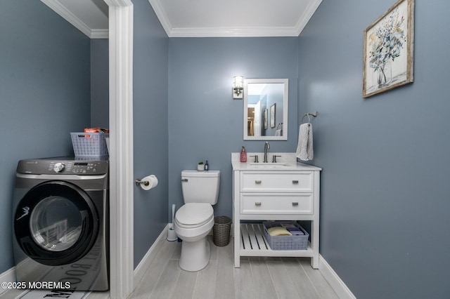 half bath with washer / dryer, toilet, baseboards, and ornamental molding