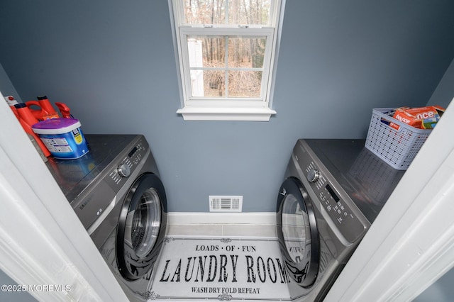 laundry room featuring laundry area, visible vents, and washing machine and clothes dryer