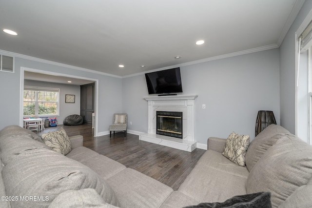 living area featuring crown molding, wood finished floors, and a premium fireplace