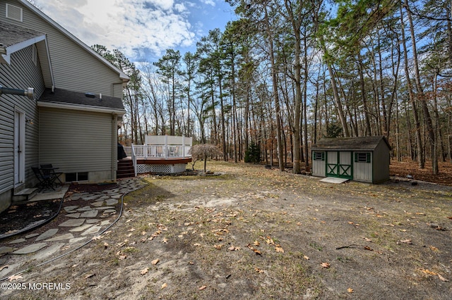 view of yard with a storage unit, an outdoor structure, and a deck