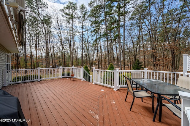 wooden terrace featuring outdoor dining space