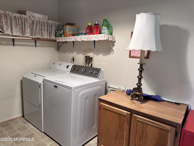 clothes washing area featuring cabinet space and independent washer and dryer