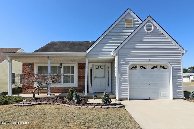 single story home with brick siding, a porch, concrete driveway, and an attached garage