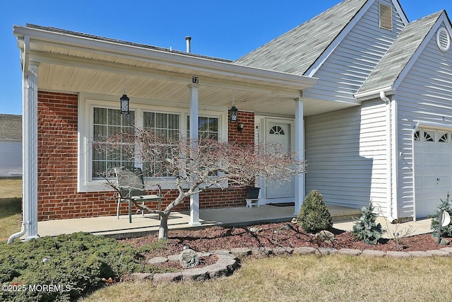 view of front facade with brick siding and a porch