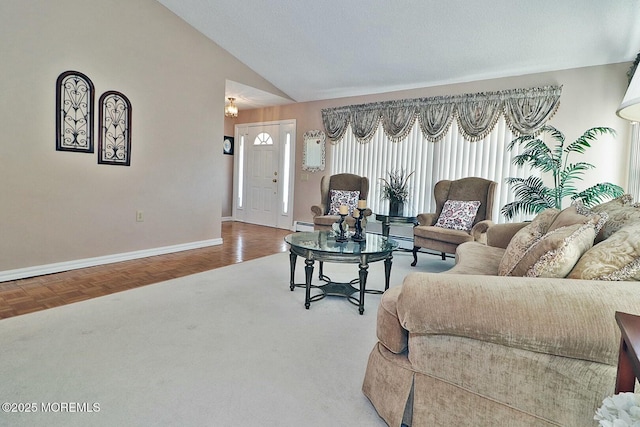 living area featuring high vaulted ceiling, baseboards, and a baseboard radiator