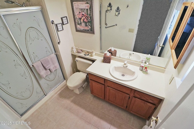 bathroom with vanity, a shower stall, toilet, and tile patterned flooring