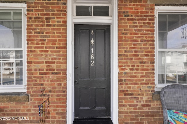 property entrance with brick siding