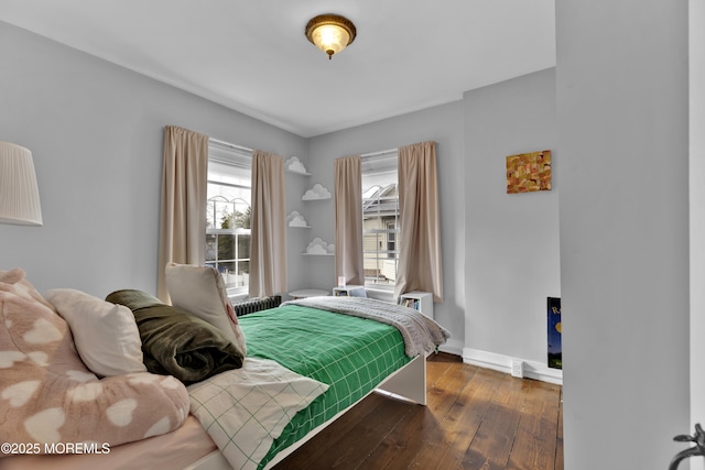 bedroom with baseboards and hardwood / wood-style flooring