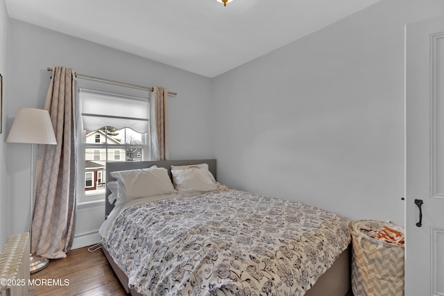 bedroom with hardwood / wood-style flooring