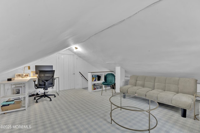 carpeted office featuring lofted ceiling