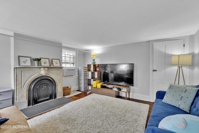 living room with cooling unit, a fireplace, dark wood-type flooring, and baseboards